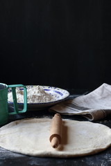 Dough ,making dough with flour on a black background, bread and pizza dough