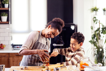 Woman prepare pie in the kitchen and learn his son cooking