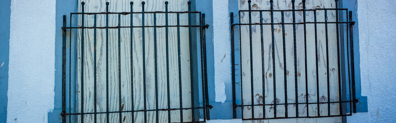 Close up of two Windows with black iron bars