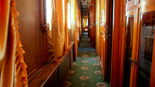 Interior Of Old Wooden Train Wagon With Wooden Walls And Carpets On Floor
