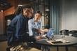 © Flamingo Images - Two young businesspeople working on a laptop together