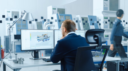 Poster - Industrial Engineer Solving Problems, Working on a Personal Computer, Two Monitor Screens Show CAD Software with 3D Prototype of Hybrid Electric Engine Being Tested. Working Modern Factory.