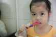 © jaturapat - Little asian cute girl brush teeth