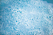 Abstract background made of white foam bubles on blue color water