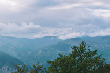 A picturesque wide landscape view of the hazy valley of Var in the Alps mountains (Col de Rigaudon, Alpes-Maritimes, France)