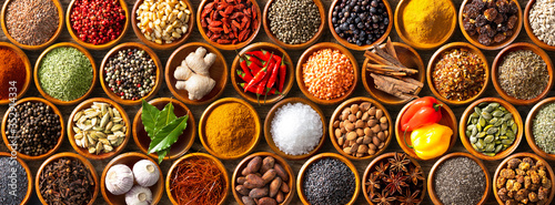 Tela Colourful background from various herbs and spices for cooking in bowls