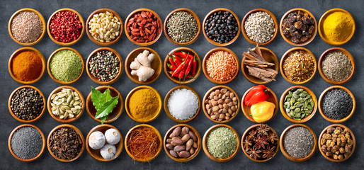 Wall Mural - Colourful background from various herbs and spices for cooking in bowls