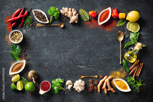 Papel de parede Colourful various herbs and spices for cooking on dark background