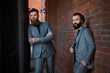 © Наталья Бирюкова - two guys in gray suits against a brick wall