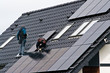 © AHatmaker - Installing solar panels on the roof of private house