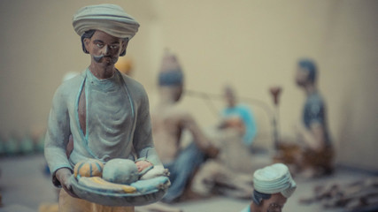 Wall Mural - Sculpture of a man with tray of fruits