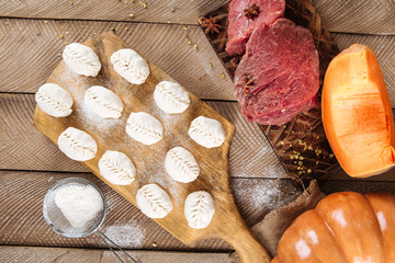 Wall Mural - Semi-finished manti dumplings on the wooden board