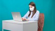© Евгения Медведева - woman working at home with medical mask on face. coronavirus quarantine remote home working concept.