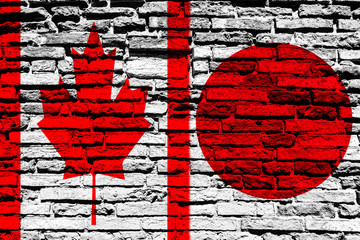 Flag of Canada and Japan on brick wall