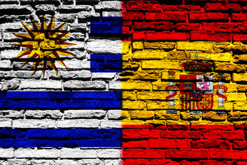 Flag of Uruguay and Spain on brick wall