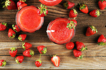 Wall Mural - Glass of Sweet fresh strawberry juice and fresh strawberries on table. Healthy food and drink concept