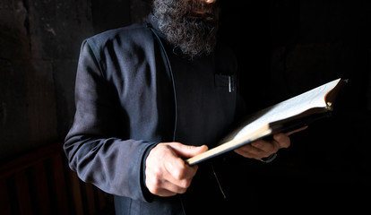 Canvas Print - Bible in the hands of the priest