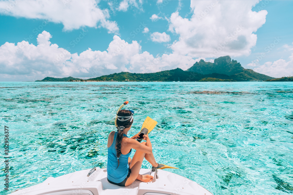 Snorkel diving excursion boat tour from yacht luxury travel influencer going swimming in coral reefs of Tahiti, French Polynesia Bora Bora island. - obrazy, fototapety, plakaty 