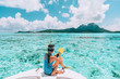 Snorkel diving excursion boat tour from yacht luxury travel influencer going swimming in coral reefs of Tahiti, French Polynesia Bora Bora island.