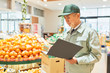 © imagenavi - Senior man manager in supermarket (stock control)