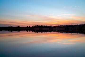 Spring sunset over the lake in calm weather . Vsevolozhsk. Leningrad region .