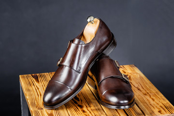 stylish leather brown shoes against a dark background.