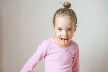 Little cute girl depicts emotions. Fun, joy, laughter