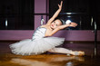 © Vadim - Little cute girl in white leotard making new ballet movement at dance studio