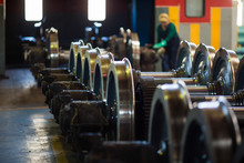 Axles With Wheels Of Railway Cars Lie In A Row At A Repair Plant