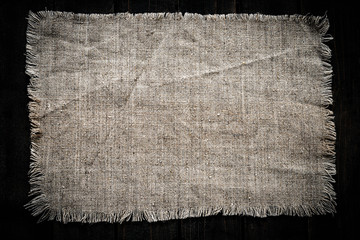 old vintage linen fabric frame patch on wooden background