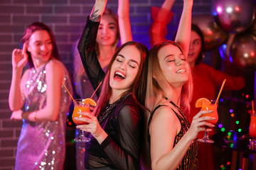 Poster - Beautiful young women dancing in night club