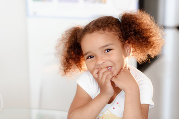 Wall Mural - Head shot portrait healthy attractive mixed race little girl with curly ringlets hairstyle and pretty face posing indoor looking at camera. Natural beauty innocence and new generation concept/