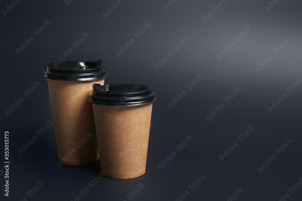 Takeaway cups for drink on dark background