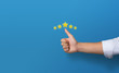© sichon - Businessman showing giving a five star rating and thumb up with on blue background. Service rating, satisfaction concept