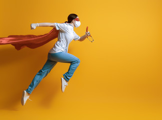 Doctor wearing facemask and superhero cape