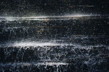 Poster - Vertical shot of a hard rain flowing from stairs in the street