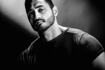 Bw portrait of handsome brutal young man with confident expression