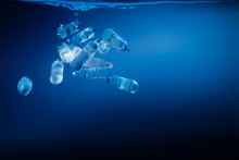 Plastic Bottles Sinking In To The Ocean. Enviromental Polution Concept. World Ocaens Day