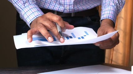 Sticker - businessman analyzing financial data at office desk 