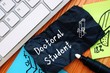 Business concept about Doctoral Student with sign on the piece of paper.