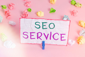 Poster - Text sign showing Seo Service. Business photo text techniques and procedures to increase the website visibility Colored crumpled papers empty reminder pink floor background clothespin