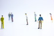 © Yuan - miniature businessmen keep distance away in the public. Social distancing concept avoid COVID-19 coronavirus spreading.