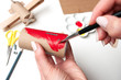 Step by step creating aircrat airplane toy, painting in red part of model made from paper. Diy for kids. Daily activites