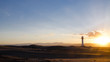 © Xavier - Sunset in the Ebro's delta. There is a lighthouse over the dunes with mountains in the background.Tarragona, Barcelona, Catalonia, Spain.