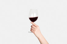 Young Girl Holding Glass Of Tasty Red Wine On White Background, Closeup