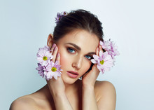 Portrait Of A Beautiful Natural Blue-eyed Girl With Lilac Flowers In The Wild. Nude Make-up.
