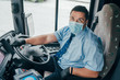 bus driver wears face mask and protecting gloves