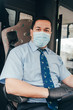 clouse up portrait of hispanic bus driver with protecting mask