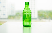 Transparent Glass Of Water With Air Bubbles Green Glass Bottle