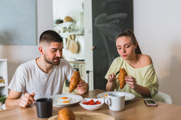 Wall Mural - romantic man and woman couple having breakfast at home